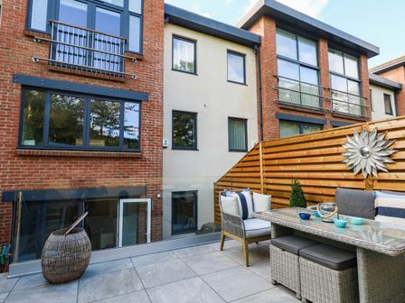 An outdoor area with furniture and a fence at Harbour Heights in Weymouth
