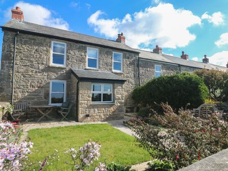A house with garden furniture and plants at 12 Boswedden Terrace in St Just