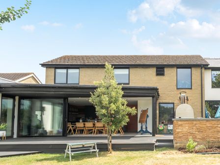 An outdoor area with a house and seating at Manor Farm House in Merton near Bicester