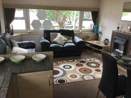 a living room with a sofa, coffee table, and decorative rug at Waterside, Paignton - Holiday Accommodation 10036, Paignton