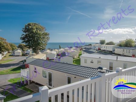 a view of holiday caravans overlooking the sea at Grand Coastal Retreats