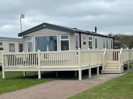 a holiday home with a deck and ramp at Skipsea Sands Holiday Park - Holiday Accommodation 11304, Driffield