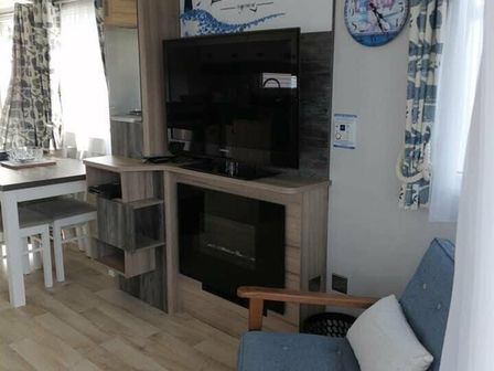a living room with a television and seating area at Seashore Holiday Park - Holiday Accommodation 12106 in Great Yarmouth