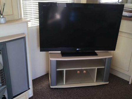 a television on a stand in a room at Edwards Leisure Park - Holiday Accommodation 13452 in Towyn