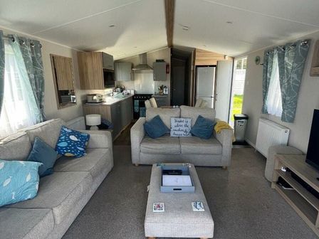 a living room with a sofa and coffee table at Bideford Bay Holiday Park - Holiday Accommodation 13835 in Bideford