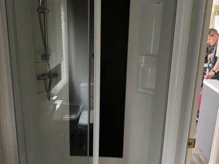 a bathroom featuring a shower, toilet, and sink at Devon Cliffs Holiday Park - Holiday Accommodation 14385 in Exmouth
