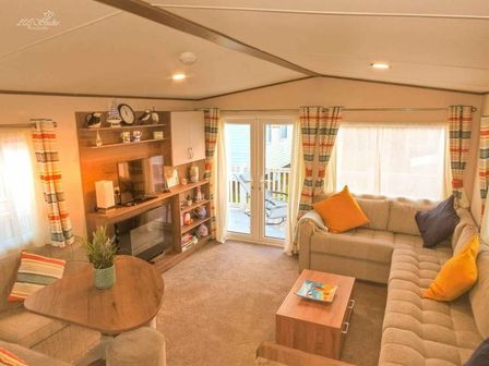 a living room with a sofa, coffee table, and TV area at Hoburne Blue Anchor - Holiday Accommodation 14435, Blue Anchor