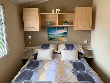 a bedroom with a bed, shelves, and artwork at Seven Bays Park (Maribou) - Holiday Accommodation 14557, Padstow