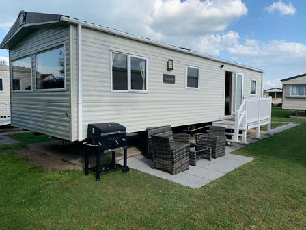 a holiday home with outdoor seating and a barbecue at Burnham-on-Sea Holiday Park - Holiday Accommodation 14702 in Burnham-on-Sea