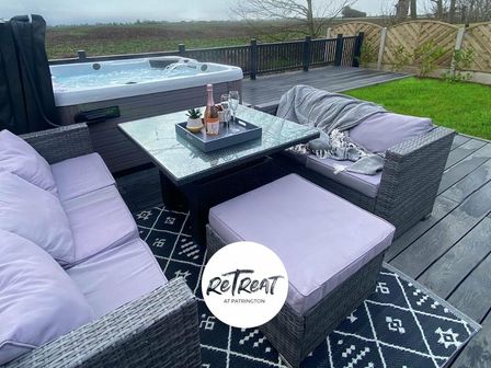 a seating area with a hot tub and outdoor furniture at RetTreat at Patrington