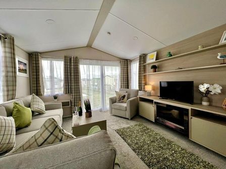 a living room with a television, a sofa, and curtains at Seven Bays Park (Maribou) - Holiday Accommodation 14886, Padstow