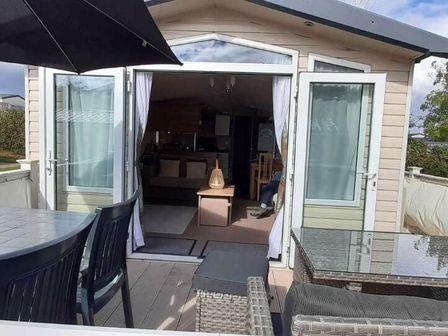 an outdoor seating area with a view into a living space at Hoburne Devon Bay - Holiday Accommodation 14911, Paignton