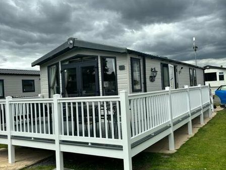 a holiday home with a deck and grey exterior at Tattershall Lakes Country Park - Holiday Accommodation 15201 in Lincoln