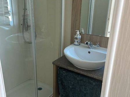 a bathroom with a shower and a sink at Lido Beach Holiday Park - Holiday Accommodation 15292 in Prestatyn