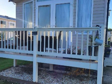 a porch with a railing and seating area at Weymouth Bay Holiday Park - Holiday Accommodation 15694, Preston