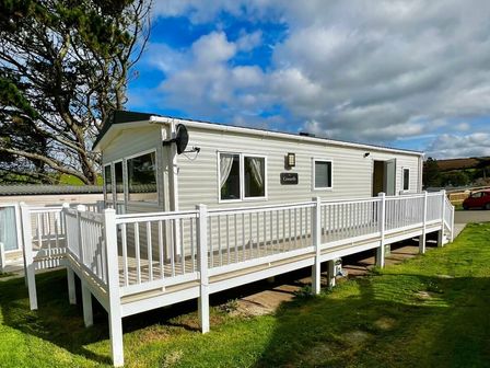 a holiday home with a wooden deck and white railing at Newquay Bay Resort - Holiday Accommodation 15978, Newquay