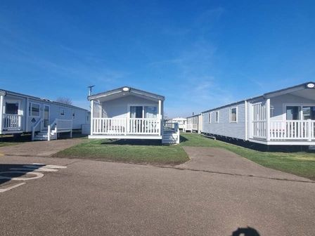 two holiday caravans with white exteriors and porches at Caister Holiday Park - Holiday Accommodation 17349 Caister-on-Sea