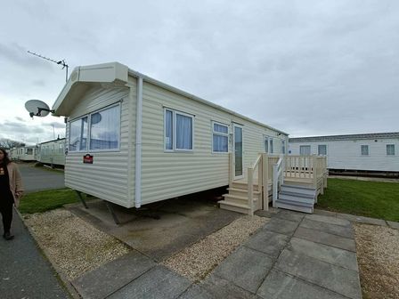 a static caravan with stairs and a satellite dish at Lyons Robin Hood - Holiday Accommodation 17428 in Rhyl