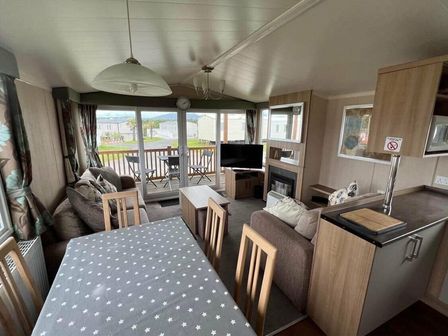 a living room with a dining area and seating at Hafan y Mor Haven - Holiday Accommodation 17436 in Pwllheli