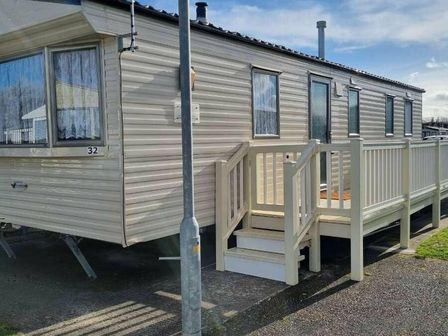 a caravan with a porch and stairs at Happy Days Caravan Park - Holiday Accommodation 17569 Towyn