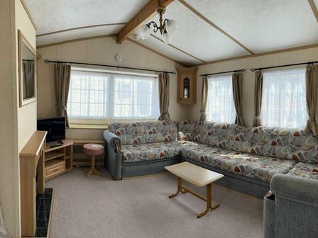 a living room with a sectional sofa and television at Marsh Farm Holiday Park - Holiday Accommodation 17737 in Great Yarmouth