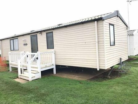 a static caravan with a porch and steps at Hopton Holiday Village - Holiday Accommodation 17811 in Hopton On Sea