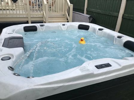 a hot tub with water and a rubber duck at Golden Sands Kinmel Bay - Holiday Accommodation 17918, Rhyl