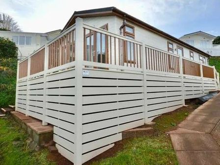 a white wooden deck with railings surrounding a holiday home at Waterside, Paignton - Holiday Accommodation 17933, Paignton