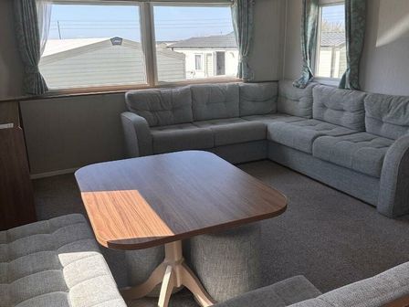 a corner seating area with a table at Littlesea Holiday Park - Holiday Accommodation 18892 in Weymouth