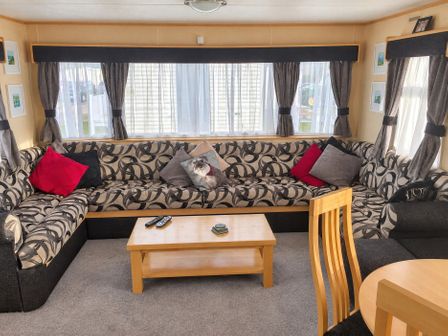 A living room with a sofa and coffee table at Presthaven Beach Resort - Holiday Accommodation 18911, Prestatyn