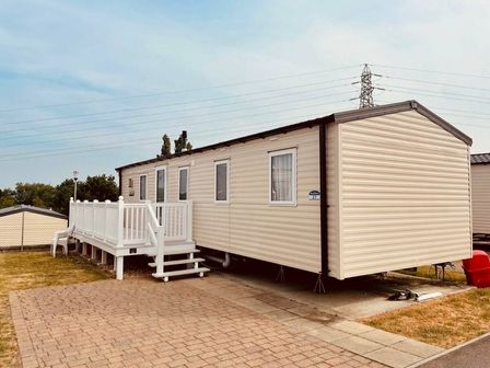 a mobile home with a deck and steps at Rockley Park - Holiday Accommodation 19172 in Poole