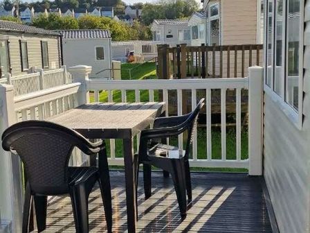 a small outdoor patio with a table and chairs at Hoburne Devon Bay - Holiday Accommodation 19431 in Paignton