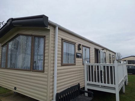 a mobile home with a porch and windows located at Broadland Sands - Holiday Accommodation 19629 in Lowestoft