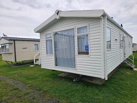 a holiday caravan with a large window and steps at Caister Holiday Park - Holiday Accommodation 19814, Caister On Sea