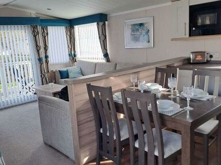 a living room with a dining area and a sofa at Cala Gran Holiday Park - Holiday Accommodation 20084 in Fleetwood