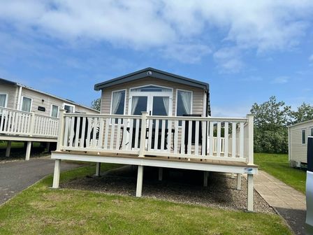 a holiday home with a deck and steps at Blue Dolphin Holiday Park - Holiday Accommodation 20187 in Filey