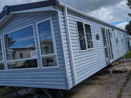 a static caravan with multiple windows and a deck in Lyons Winkups and Primrose - Holiday Accommodation 20357 Towyn