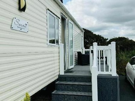an entrance with steps leading up to a caravan at Liskey Hill Caravan Park - Holiday Accommodation 20540, Perranporth