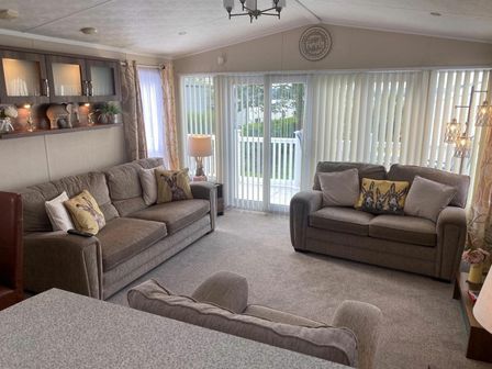 a living room with two sofas and a lamp at Rockley Park - Holiday Accommodation 20893 in Poole