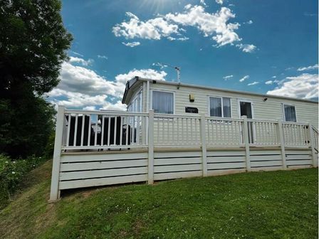 a holiday home with a deck and grass area at Hoburne Devon Bay - Holiday Accommodation 20955 in Paignton