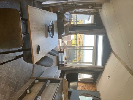 a living room and dining area with a table and chairs at Sandy Bay Holiday Park - Holiday Accommodation 21038 Newbiggin By The Sea
