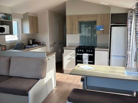 a kitchen and dining area with cabinets and a couch at Cala Gran Holiday Park - Holiday Accommodation 21106, Fleetwood