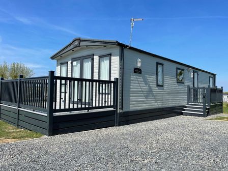 a holiday home with a deck and steps at Seven Bays Park (Maribou) - Holiday Accommodation 21126, Padstow