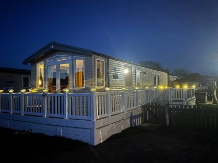 a holiday home exterior with a deck and lights at Patrington Haven Leisure Park - Holiday Accommodation 21128, Patrington