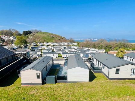a view of holiday homes and a hill in the background at Waterside, Paignton - Holiday Accommodation 21234 in Paignton