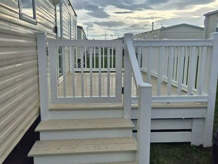 a white deck with steps at Lyons Robin Hood - Holiday Accommodation 21327 in Rhyl