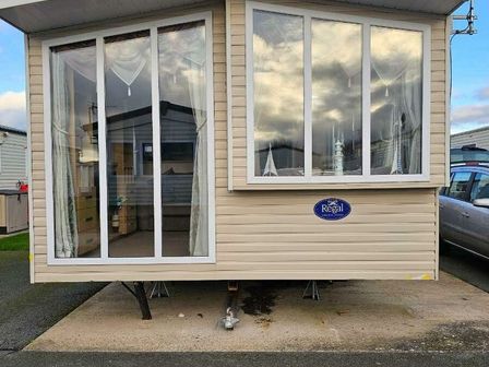 a caravan with large windows and curtains at Oakfield Caravan Park - Holiday Accommodation 21486 in Rhyl