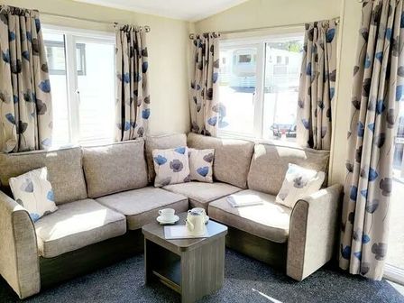 a corner seating area with cushions and a coffee table at Waterside, Paignton - Holiday Accommodation 21747