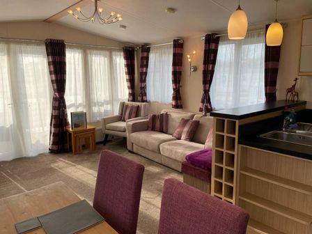 a living room with large windows and a seating area at Rockley Park - Holiday Accommodation 21974 Poole, Dorset, United Kingdom
