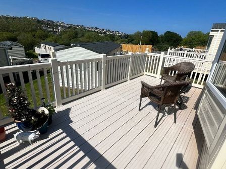 a balcony with a chair and plants at Hoburne Devon Bay - Holiday Accommodation 22090, Paignton
